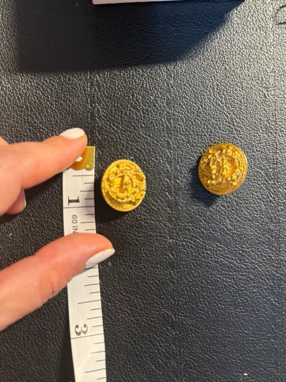CHANEL Gold Tone Embossed Logo Cuff Links